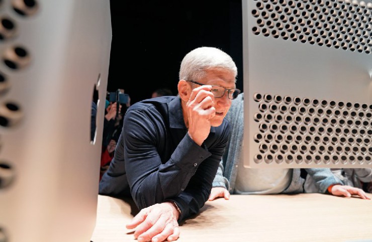 Apple CEO Tim Cook inspects one of the company