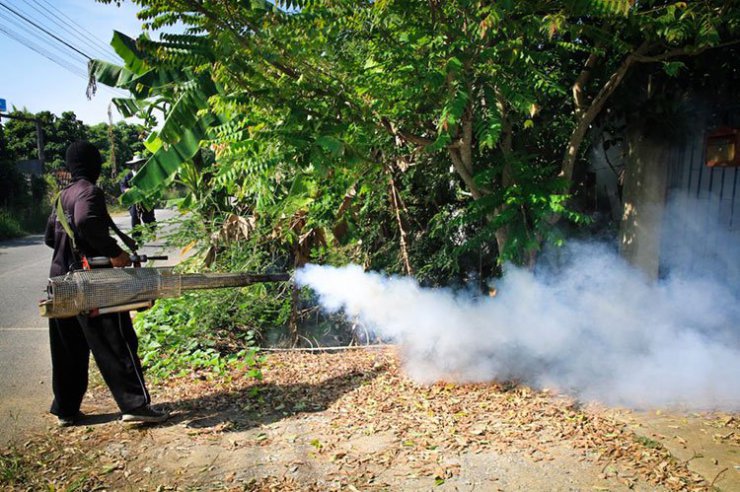 A worker sprays pesticide to kill mosquitoes that carry the Zika virus