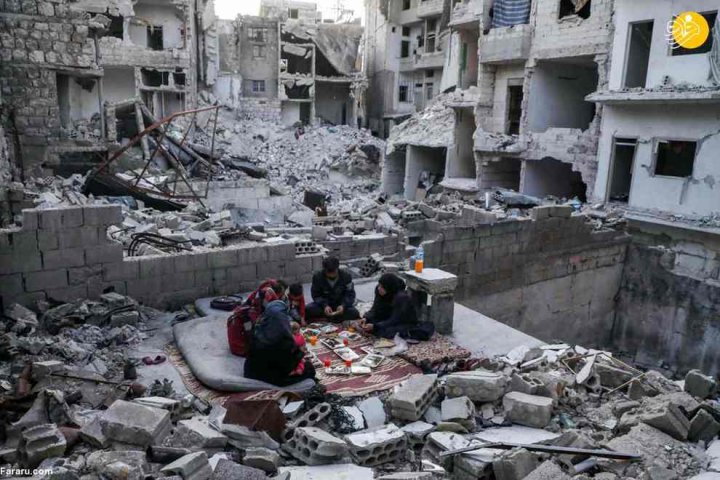 (تصاویر) افطار خانواده سوری در میان خرابه‌های خانه ویران‌ شده